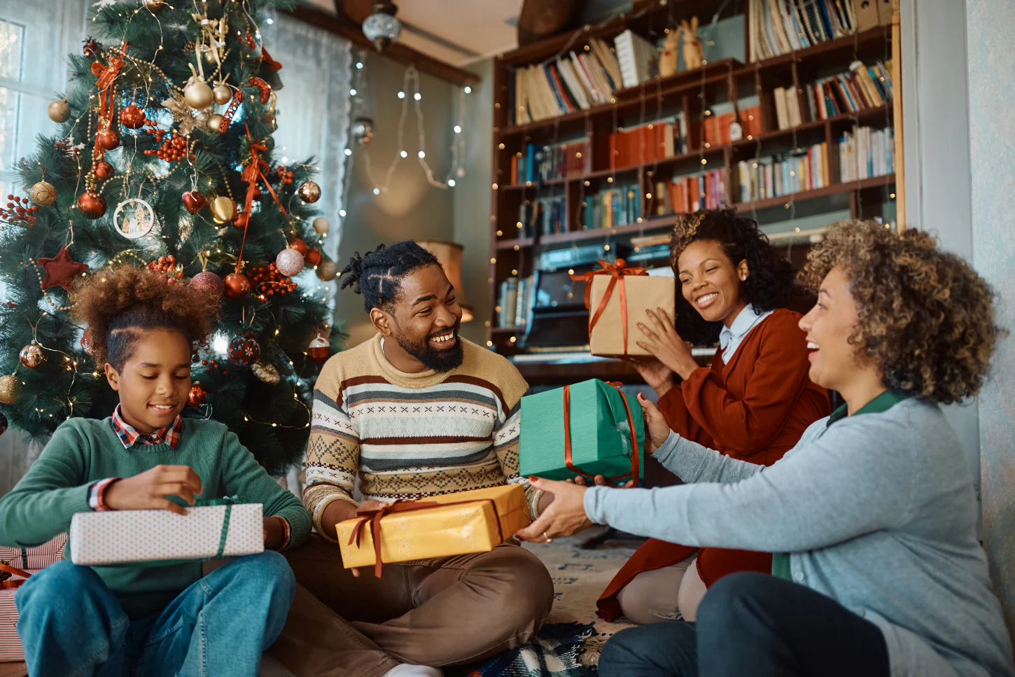 multi generation family exchanging christmas gifts 1
