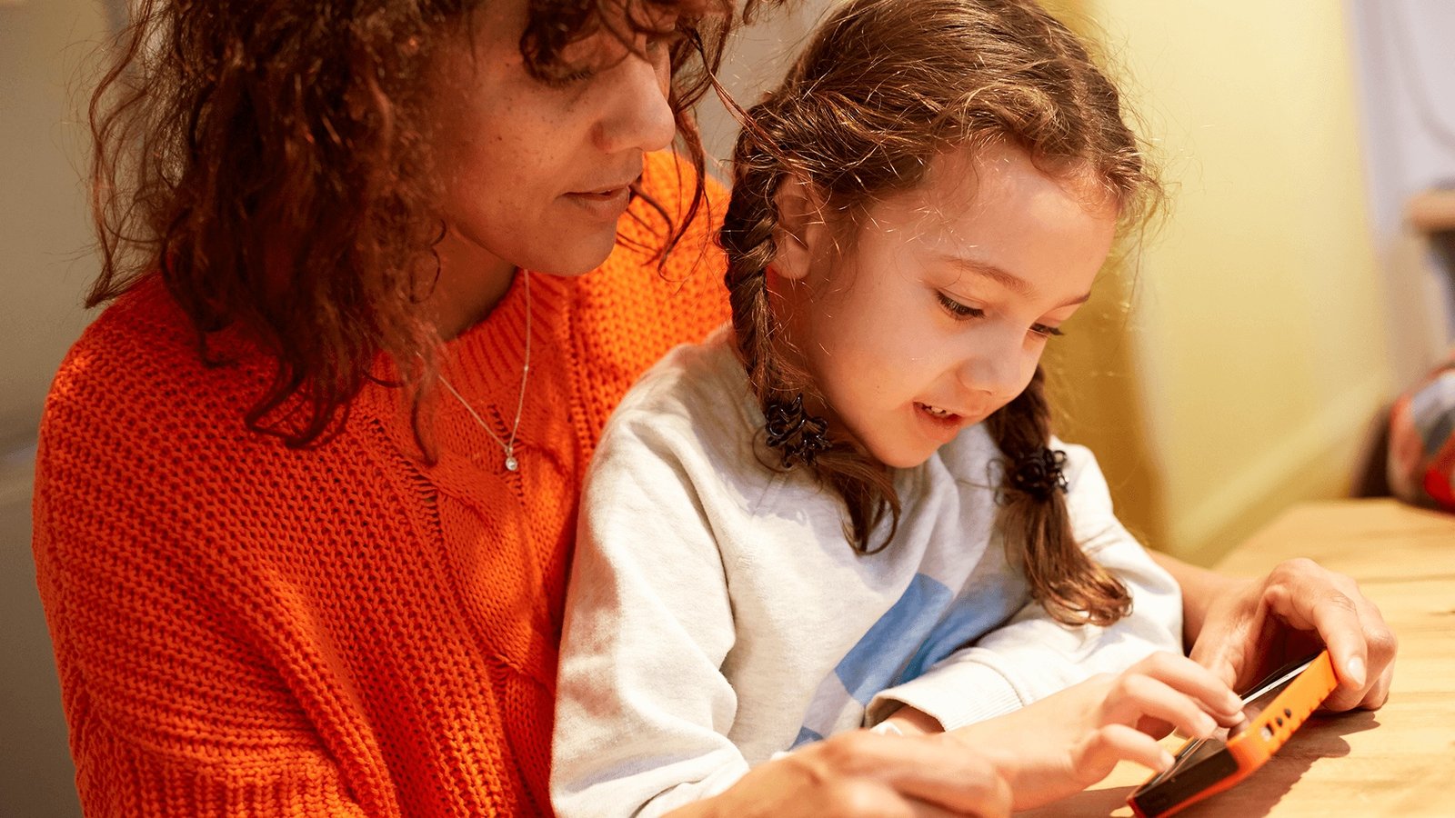 parent and child looking at a ph 1
