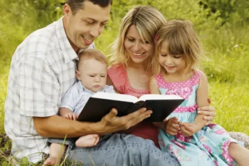 young family reading bible nature 41937327 1