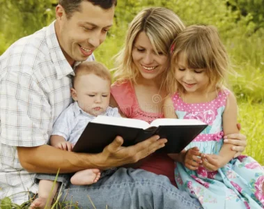 young family reading bible nature 41937327 1